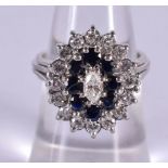 AN 18CT GOLD DIAMOND AND SAPPHIRE CLUSTER RING. 9.3 grams. M.