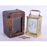 AN ANTIQUE LEATHER CASED BRASS CARRIAGE CLOCK. 18 cm high inc handle.