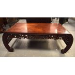 A 19TH CENTURY CHINESE CARVED HARDWOOD SCROLLING OPIUM TABLE. 99 cm x 45.5 cm.