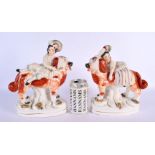 A LARGE PAIR OF 19TH CENTURY STAFFORDSHIRE FIGURS modelled as children riding upon dogs. 24 cm x 16