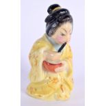 Royal Worcester candle-snuffer of the Japanese Geisha, wearing a yellow rob, date mark 1912 7x3.5cm