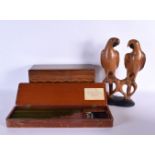 A CASED INSTRUMENT SET together with a box & pair of parrots. Largest 40 cm long. (3)