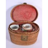 A LATE 19TH CENTURY CHINESE CANTON FAMILLE ROSE TEAPOT within original wicker case, with matching te