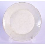 A RARE CHINESE PALE CREAM GLAZED FOLIATE RIM DISH Song/Yuan dynasty. 13 cm wide. Note: See Sothebys,