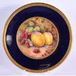 Royal Worcester fine plate painted with fruit on a rich cobalt blue ground with acid etched gilding