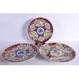 THREE 19TH CENTURY JAPANESE MEIJI PERIOD IMARI PLATES painted with landscapes. 30 cm wide. (3)