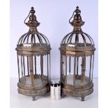 A pair of bronzed metal and glass storm lanterns 61cm (2).