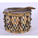 A CHARMING EDWARDIAN ENAMELLED BRONZE BOX AND COVER formed as a drum decorated with garnet and turqu