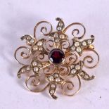 A YELLOW METAL GARNET AND SEED PEARL BROOCH. 2.8 grams. 2.5 cm wide.