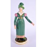 AN EARLY 19TH CENTURY DERBY FIGURE OF A FEMALE modelled wearing a green dress. 20 cm high.