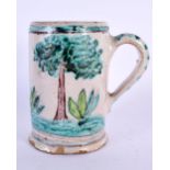 AN 18TH/19TH CENTURY EUROPEAN FAIENCE POTTERY MUG painted with a roaming male. 11 cm high.