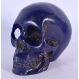 A CONTEMPORY CARVED LAPIS LAZULI TYPE SKULL. 12 cm x 10 cm.