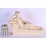 A CLASSICAL COUNTRY HOUSE PLASTER FIGURE OF A FEMALE modelled upon a relief decorated sofa. 38 cm x