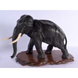 A LARGE 19TH CENTURY JAPANESE MEIJI PERIOD BRONZE AND IVORY OKIMONO modelled as a roaming elephant.