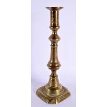 A 19TH CENTURY MIDDLE EASTERN STYLE ISLAMIC BRASS CANDLESTICK. 25 cm high.