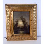 A small framed 19th Century French oil on board of a lakeside house signed with a monogram and bear