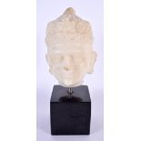 A 17TH/18TH CENTURY INDIAN CARVED MARBLE BUST modelled as a male wearing a floral embellished crown.