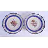 A PAIR OF 19TH CENTURY BERLIN RETICULATED PORCELAIN PLATES painted with flowers. 24 cm wide.