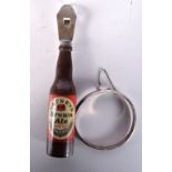 A SILVER BANGLE together with a Watneys brown ale bottle opener. Largest 14 cm long. (2)