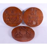 THREE VINTAGE COUNTRY HOUSE CARVED WOOD ARMORIAL PLAQUES. 20 cm diameter. (3)