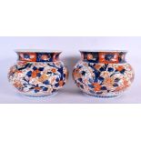 A PAIR OF 19TH CENTURY JAPANESE IMARI PORCELAIN JARDINIERES painted with flowers. 17 cm x 13 cm.