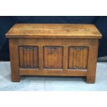 An antique heavy Oak coffer with carved panels to all aspects 56 x 94 x 49 cm.