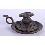 A 19TH CENTURY EUROPEAN GRAND TOUR BRONZE CHAMBERSTICK decorated with berries and vines. 13 cm wide.