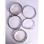 FIVE SILVER BANGLES. Stamped 925, Largest internal diameter 6.4cm, total weight 50g (5)