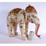 A LARGE INDIAN FOLK ART CARVED AND PAINTED WOOD CIRCUS ELEPHANT modelled with gilt embellished highl