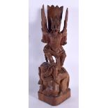 A LARGE EARLY 20TH CENTURY SOUTH EAST ASIAN JAVANESE CARVED WOOD FIGURE modelled as a demon upon an