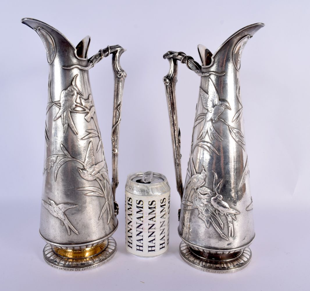 A RARE LARGE PAIR OF ELKINGTONS AESTHETIC MOVEMENT SILVER PLATED JUGS decorated all over with birds