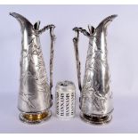 A RARE LARGE PAIR OF ELKINGTONS AESTHETIC MOVEMENT SILVER PLATED JUGS decorated all over with birds