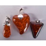 THREE SILVER AND AMBER PENDANTS. 27 grams. 5.5 cm x 3.5 cm. (3)