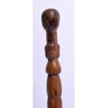 AN ANTIQUE CONTINENTAL FOLK ART CARVED WOOD TRIBAL WALKING STAFF decorated with snakes and females.