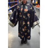 A LATE 19TH CENTURY CHINESE SILK EMBROIDERED MIDNIGHT BLUE ROBE Qing, decorated with butterflies and