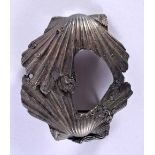 A JAPANESE MEIJI SILVER BELT BUCKLE OF SEASHELLS & FISH the two shells meeting with fish and pine