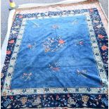 A large Chinese wool rug 300 x 253 cm