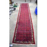 A long wool Persian runner 390 x 79 cm