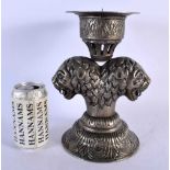 AN UNUSUAL MIDDLE EASTERN PERSIAN TWIN HANDLED WHITE METAL CANDLESTICK formed with opposing lion