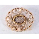 A VICTORIAN GOLD AND PEARL MOURNING BROOCH WITH A PLAITED HAIR CENTRE. 3.2cm x 2.7cm, weight 6.1g