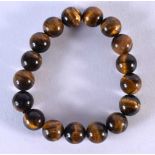 A CHINESE CARVED TIGERS EYE BRACELET. 44 grams. 5.5 cm wide.