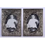 A PAIR OF 19TH CENTURY JAPANESE MEIJI PERIOD WHITE METAL PHOTOGRAPH FRAMES decorated in relief