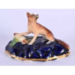 A 19TH CENTURY STAFFORDSHIRE FIGURE OF A FOX modelled with a dead bird. 8 cm x 6 cm.