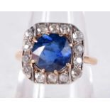 A GOLD RING WITH A SAPPHIRE SURROUNDED BY DIAMONDS, Size N, weight 5g