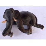 A 19TH CENTURY INDIAN CARVED HARDWOOD FIGURE OF AN ELEPHANT modelled upon its back. 27 cm x 15 cm.