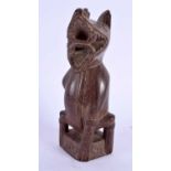 AN EARLY 20TH CENTURY POLYNESIAN TRIBAL CARVED WOOD FIGURE OF A BEAST modelled with incised