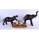 TWO EARLY 20TH CENTURY LEATHER COUNTRY HOUSE ANIMALS together with a 1940s scottie dog carved wood