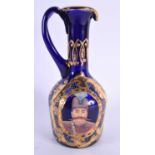 AN UNUSUAL MIDDLE EASTERN GILDED BLUE GLASS EWER depicting portraits of figures. 21.5 cm high.