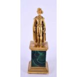 AN EARLY 19TH CENTURY FRENCH ORMOLU AND MALACHITE COUNTRY HOUSE FIGURE modelled standing clutching a