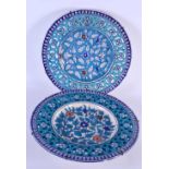A PAIR OF ANTIQUE MIDDLE EASTERN PERSIAN COUNTRY HOUSE IZNIK DISHES painted with flowers. 30 cm